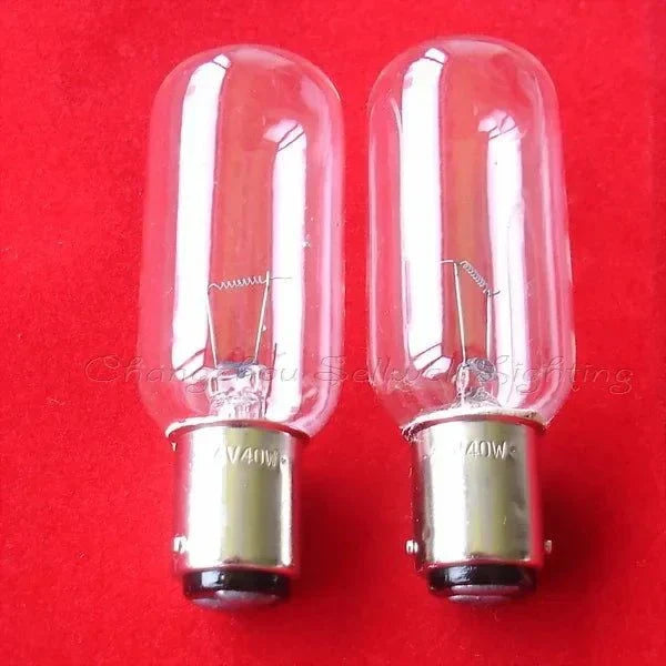 Pair of clear 24V 40W BA15D navigation lamp indicator bulbs on red background