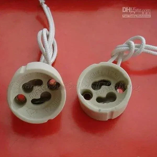 10pcs GU10 ceramics lampbase with attached wires on red background